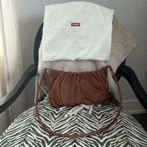STAUD leather shoulder bag/cross body bag in a brown color.